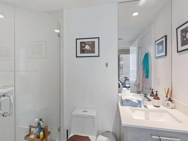 bathroom with vanity, toilet, and an enclosed shower