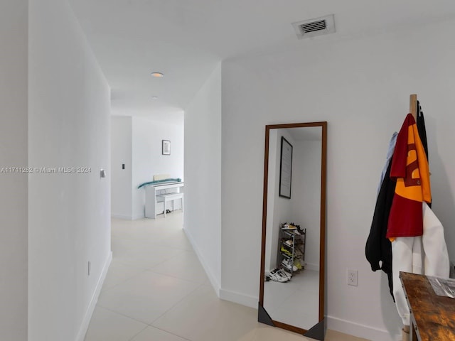 hall with light tile patterned floors