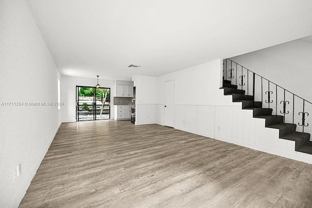 unfurnished living room with light hardwood / wood-style floors