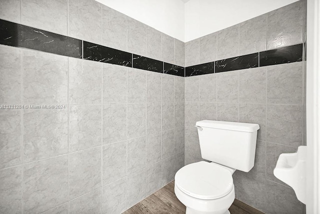 bathroom featuring toilet, tile walls, and hardwood / wood-style flooring