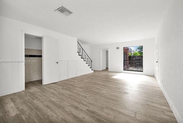 unfurnished living room featuring light hardwood / wood-style flooring