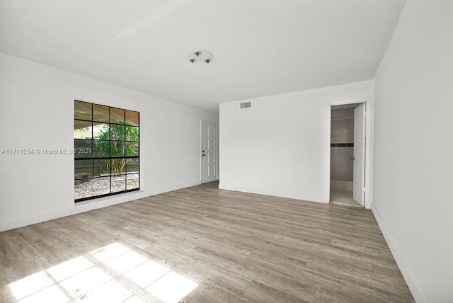 unfurnished room with light hardwood / wood-style floors