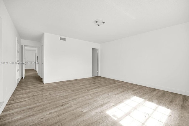 spare room with light wood-type flooring