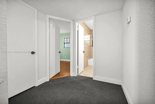 interior space with light tile patterned floors and a textured ceiling