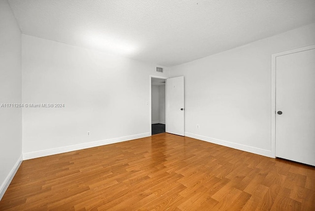 unfurnished room featuring wood-type flooring