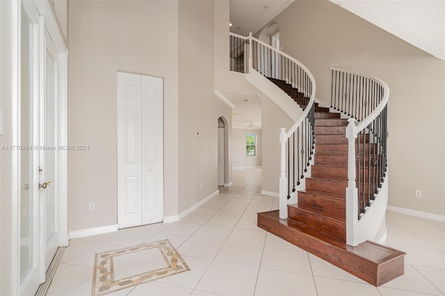 tiled entrance foyer with high vaulted ceiling