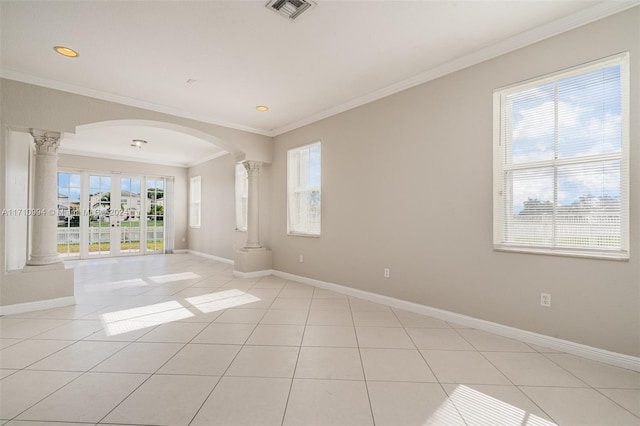 tiled spare room with ornamental molding, ornate columns, and a healthy amount of sunlight