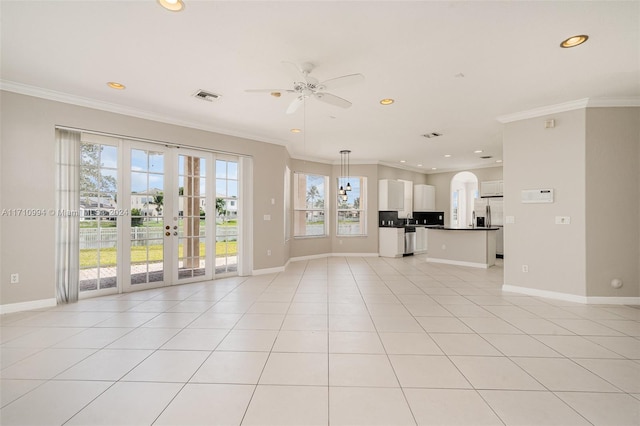 unfurnished living room with a wealth of natural light, ornamental molding, and ceiling fan