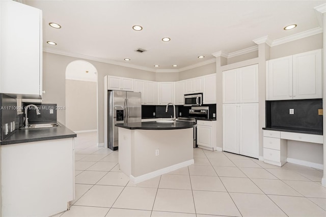 kitchen with white cabinetry, sink, decorative backsplash, a center island with sink, and appliances with stainless steel finishes