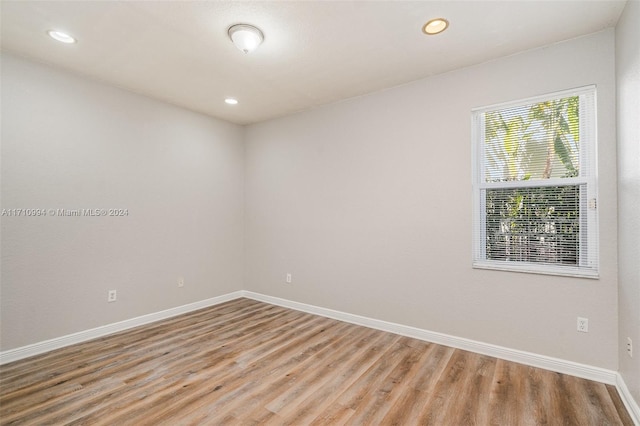 unfurnished room with light wood-type flooring