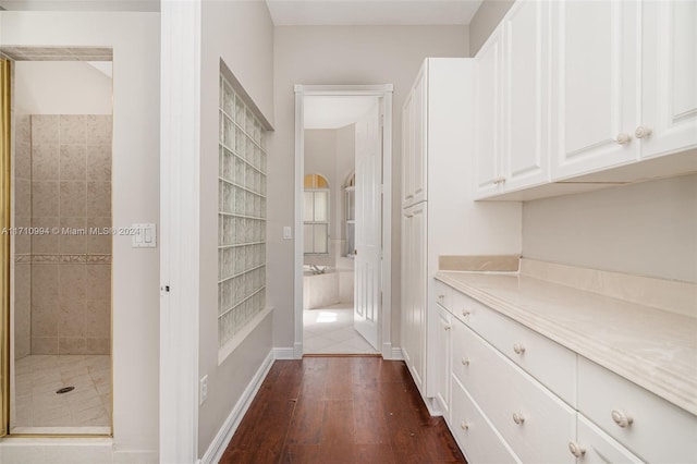 hallway with dark wood-type flooring