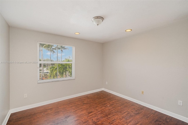 empty room with hardwood / wood-style flooring