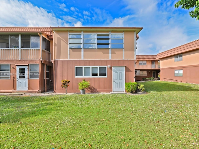 rear view of house with a yard