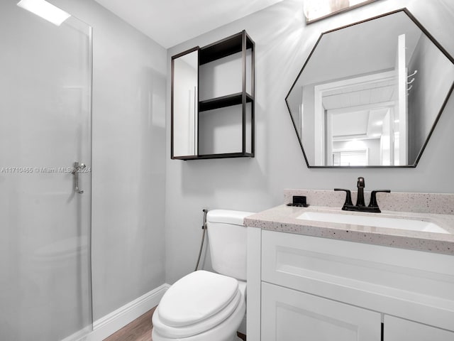 bathroom featuring hardwood / wood-style floors, vanity, and toilet