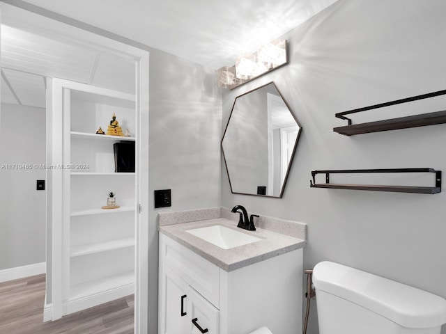 bathroom with vanity, hardwood / wood-style flooring, and toilet