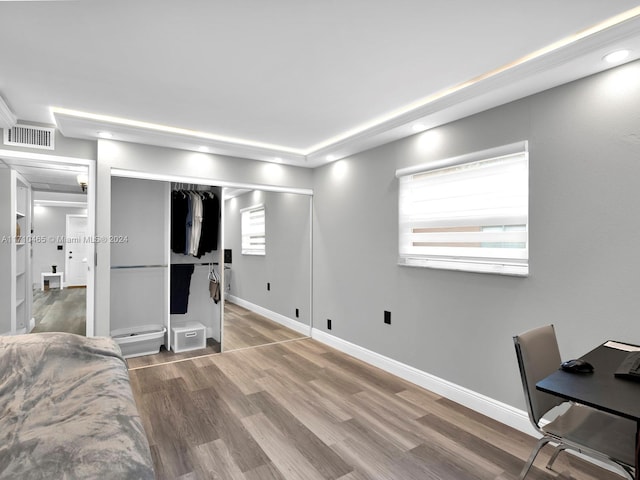 bedroom featuring hardwood / wood-style floors and a closet