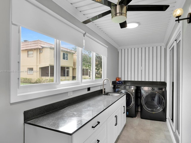 laundry area with cabinets, sink, crown molding, ceiling fan, and independent washer and dryer