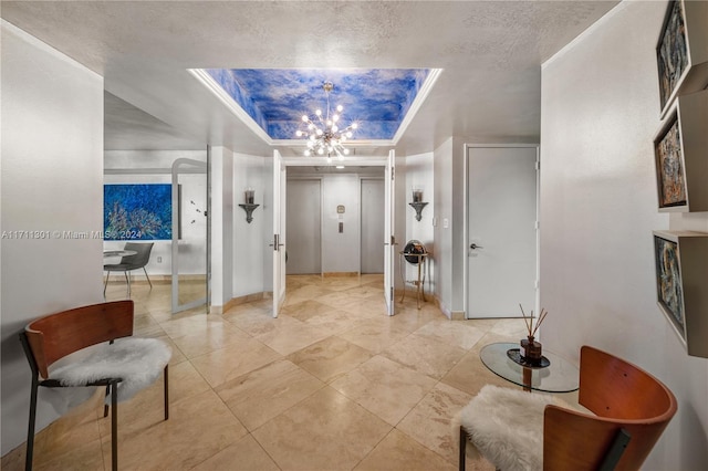 interior space with elevator, a textured ceiling, and an inviting chandelier