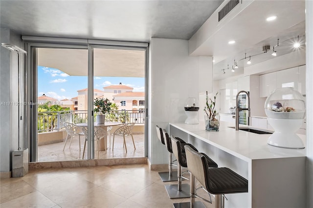 kitchen featuring white cabinets and sink