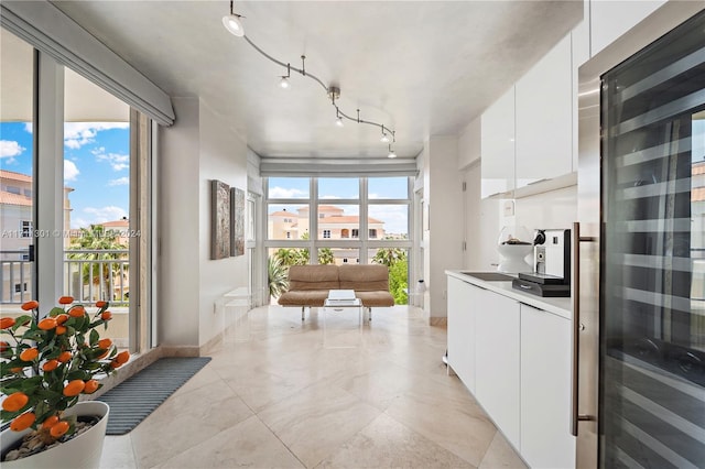 kitchen with track lighting, white cabinetry, and plenty of natural light