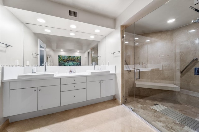 bathroom with a shower with door and vanity