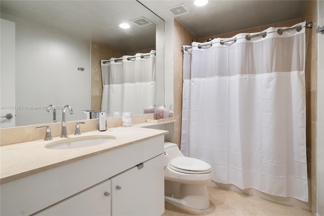 bathroom with tile patterned flooring, vanity, a shower with shower curtain, and toilet