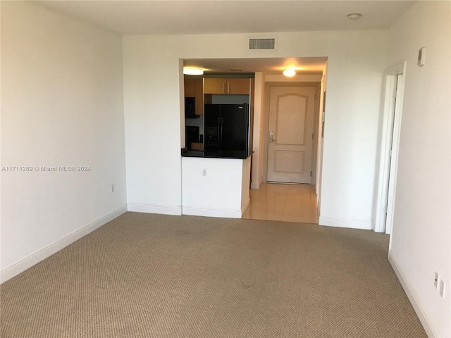 empty room featuring light colored carpet