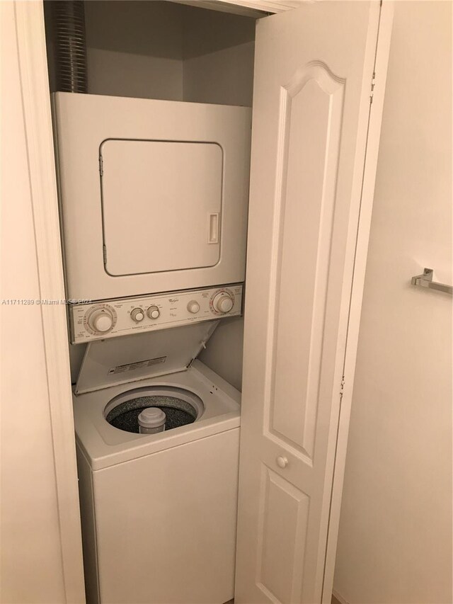 washroom featuring stacked washer and dryer