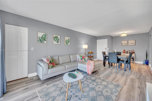 living room featuring light wood-style floors and baseboards