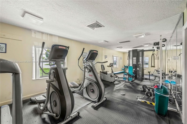 exercise room with a textured ceiling