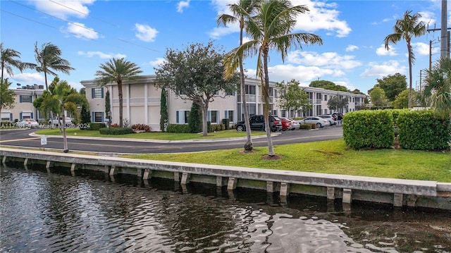 exterior space with a lawn and a water view