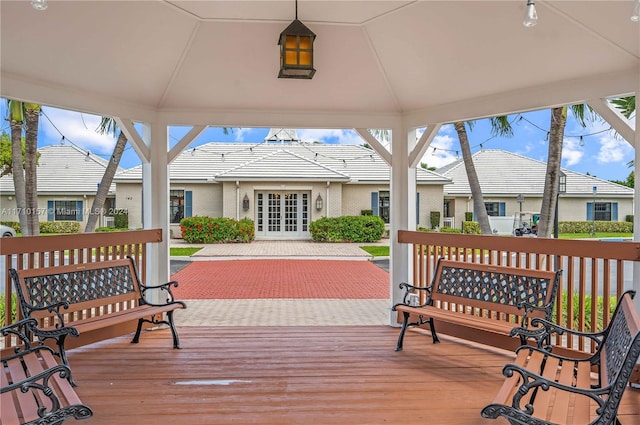 wooden terrace featuring a gazebo and french doors