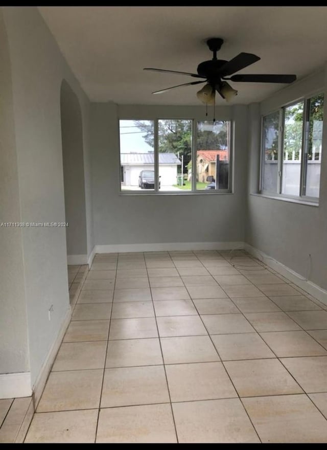 spare room featuring ceiling fan and light tile patterned floors