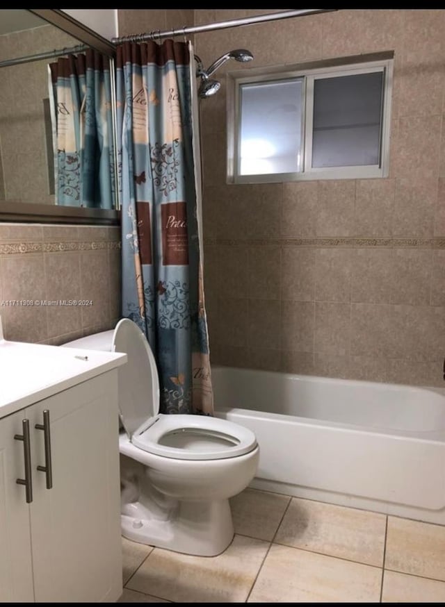 full bathroom with tile patterned flooring, shower / bath combo, vanity, and toilet