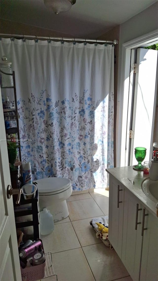 bathroom with tile patterned floors, vanity, and toilet