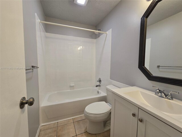 full bathroom featuring tile patterned floors, vanity, a textured ceiling,  shower combination, and toilet