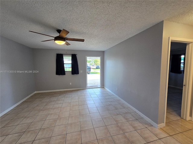 tiled spare room featuring ceiling fan and a textured ceiling