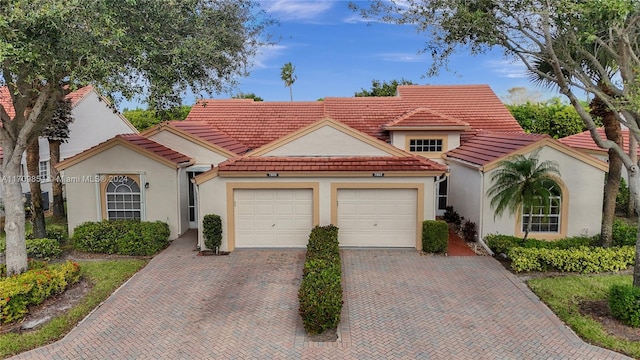 mediterranean / spanish home featuring a garage