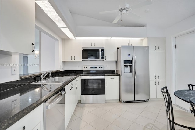 kitchen featuring appliances with stainless steel finishes, ceiling fan, sink, dark stone countertops, and white cabinets