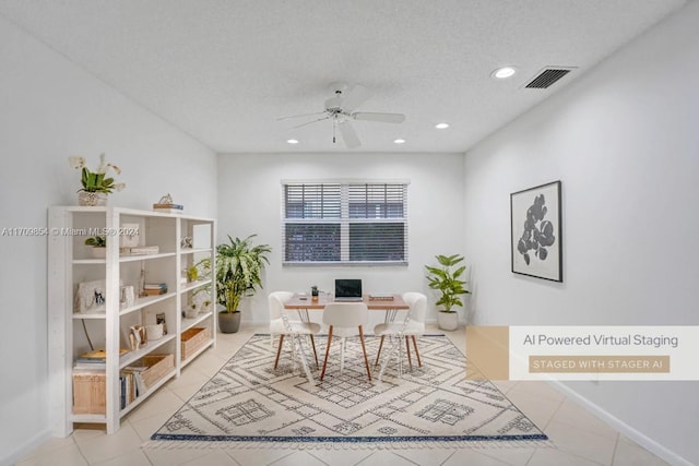 office area featuring ceiling fan, light tile patterned floors, and a textured ceiling