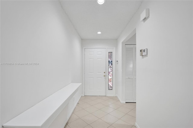 hallway featuring light tile patterned floors