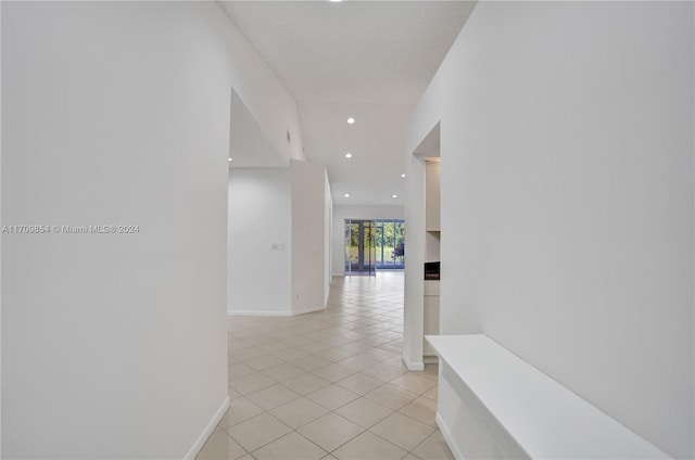 hall featuring light tile patterned floors