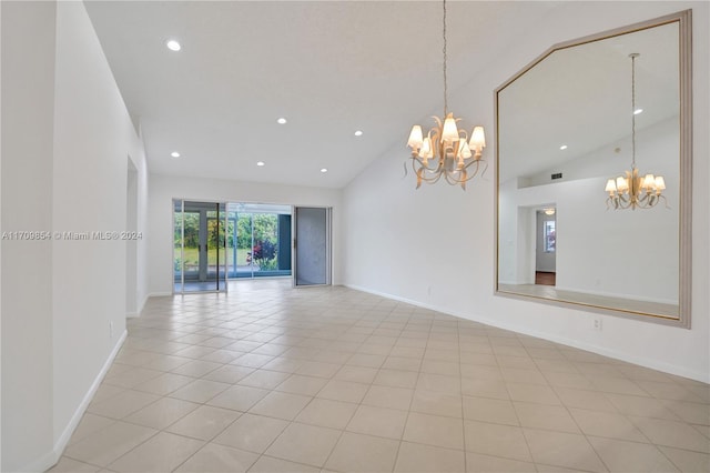 empty room with high vaulted ceiling, a chandelier, and light tile patterned floors