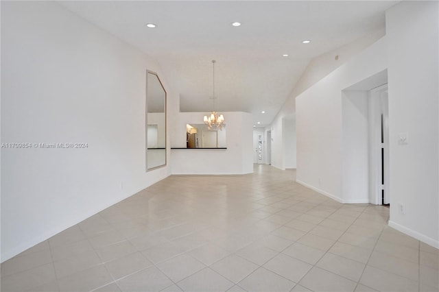 unfurnished living room with light tile patterned flooring, a chandelier, and vaulted ceiling