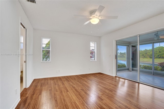 unfurnished room featuring hardwood / wood-style floors and ceiling fan