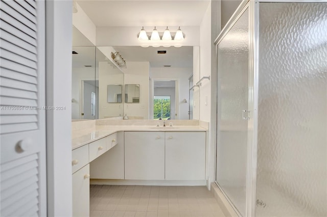 bathroom featuring vanity, tile patterned floors, and a shower with door