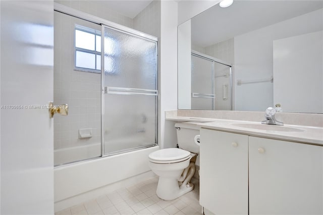 full bathroom featuring toilet, vanity, tile patterned floors, and enclosed tub / shower combo