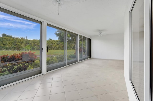 unfurnished sunroom with ceiling fan