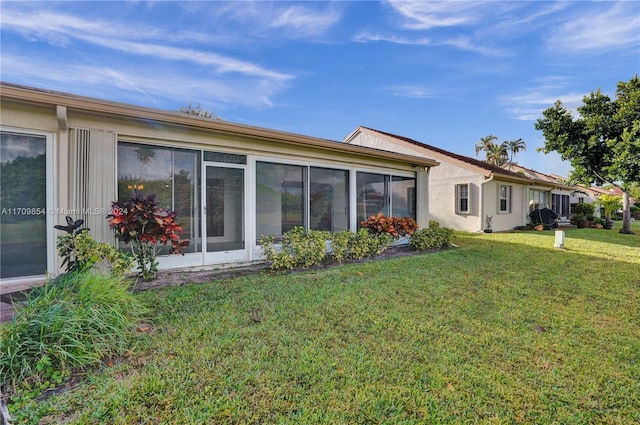 rear view of property with a lawn