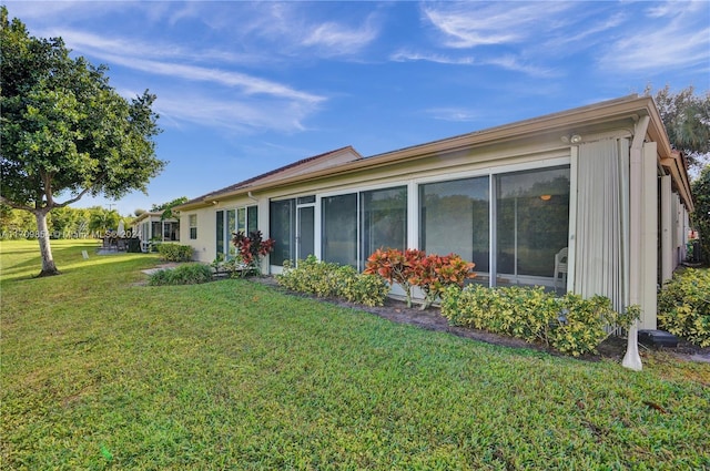 view of side of property with a lawn